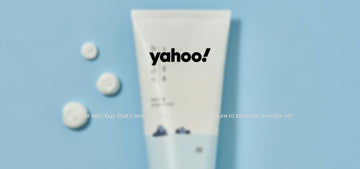 Front view of ROUND LAB 1025 Dokdo Cleanser tube with Yahoo logo and quote on a blue background