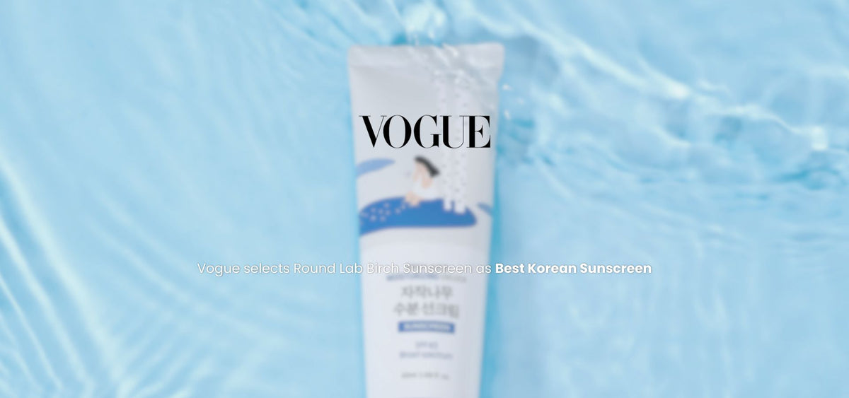Front view of Round Lab Birch Sunscreen tube against rippling blue water
