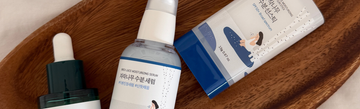 Close-up of Round Lab skincare collection showcasing serum and sunscreen on a wooden tray