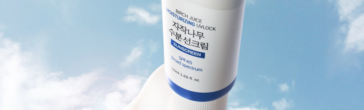 Close up of Birch Juice Moisturizing UVLock sunscreen showcasing SPF 45 and broad spectrum label against a blue sky