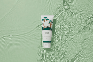 Korean skincare cleanser tube with pine tree design on clear water surface