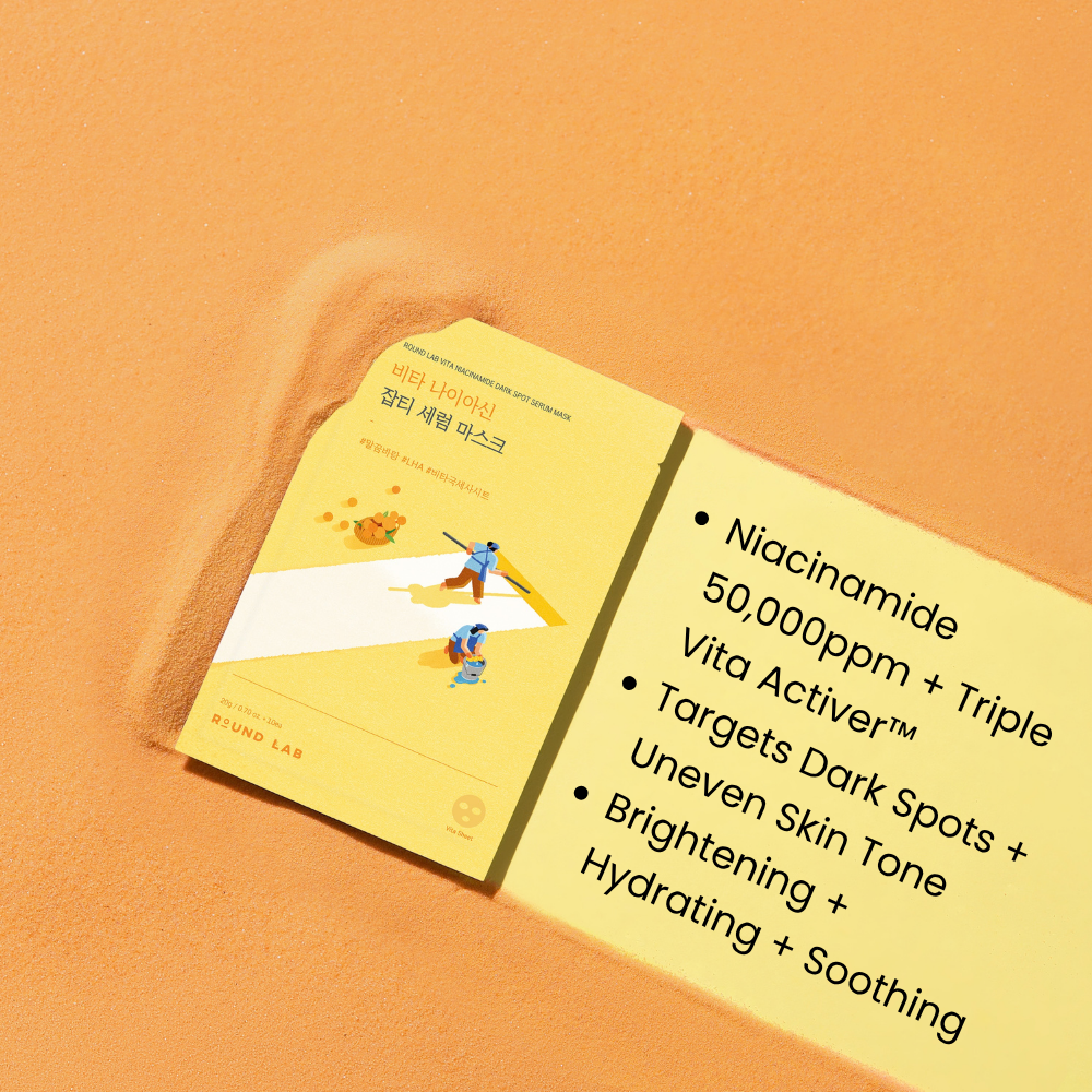Front view of Vita Niacinamide Dark Spot Serum Mask showcasing yellow packaging with a white sheet mask and serum