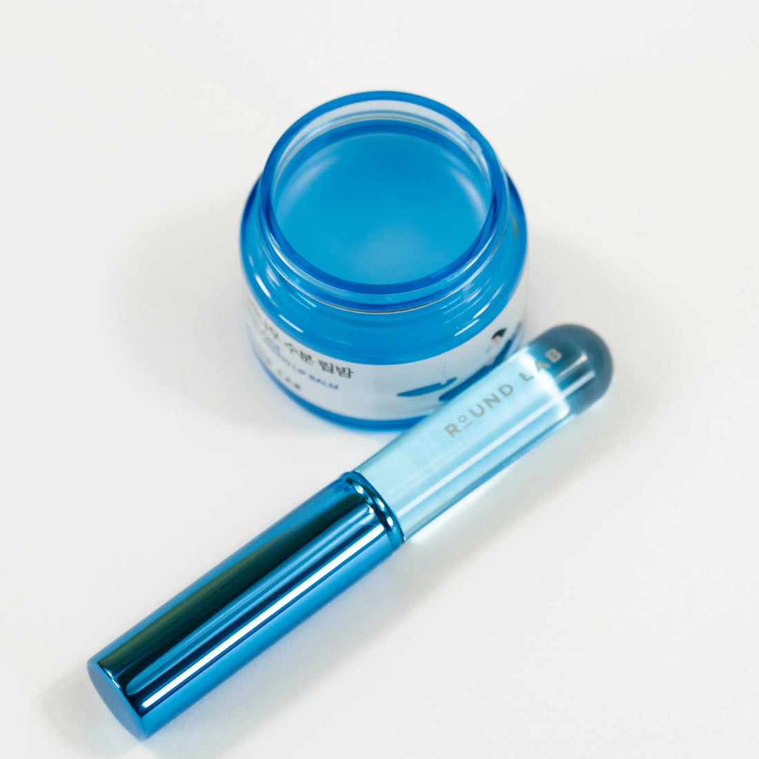 Birch Juice Moisturizing Lip Balm Set with jar, silicone brush, and box on a white background