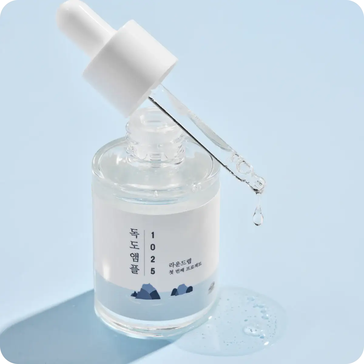 Clear skincare serum in glass bottle with dropper, Korean beauty product for hydration and glow