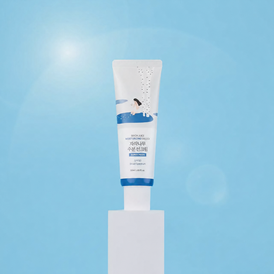 Birch Sunscreen UVLock SPF 50 – white and blue 50 ml tube standing upright on a white pedestal against a sunny light blue background